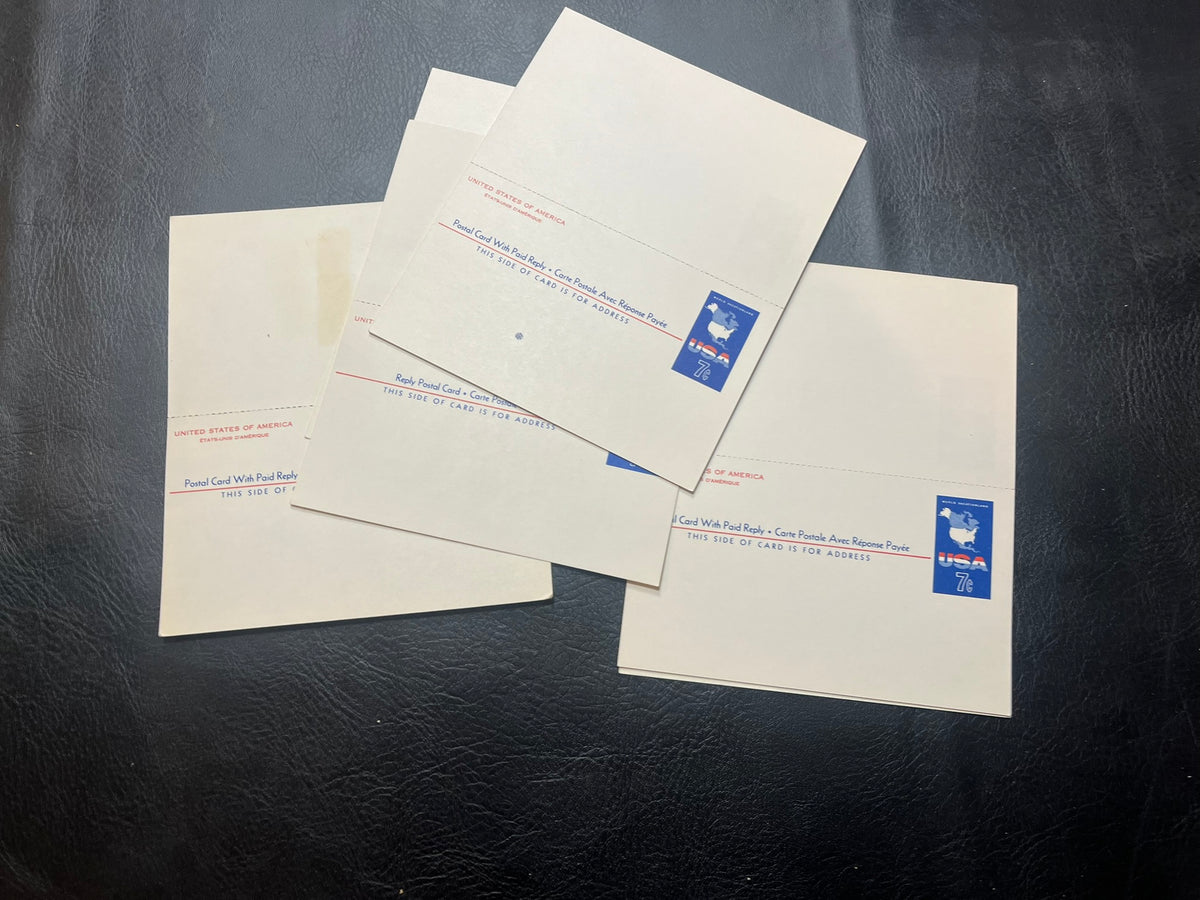 UY19   Collection of 9 - 7c World Map Vacationland Postal Cards.